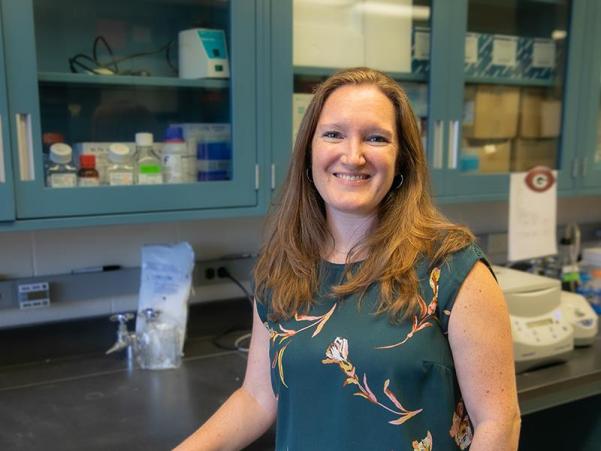 Person with hair down in front of lab bench