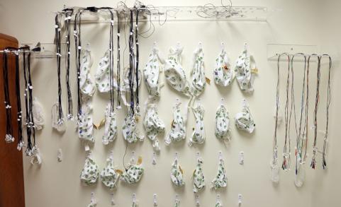 EEG caps and leads hanging on the wall