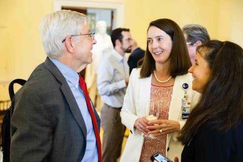 Dean Kibbe, Karen Johnston, and Walter Koroshetz socialize.