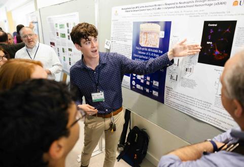 Student presents research poster.