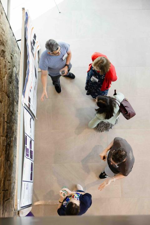 Postdoc presents research poster.