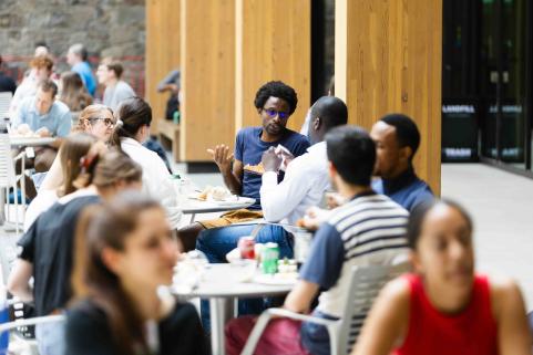 Attendees eat lunch on terrace.