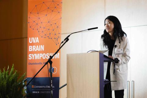 Dr. Gloria Choi presents at podium.