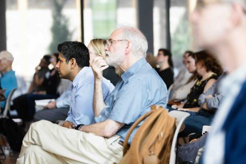 Attendees listen to lectures.